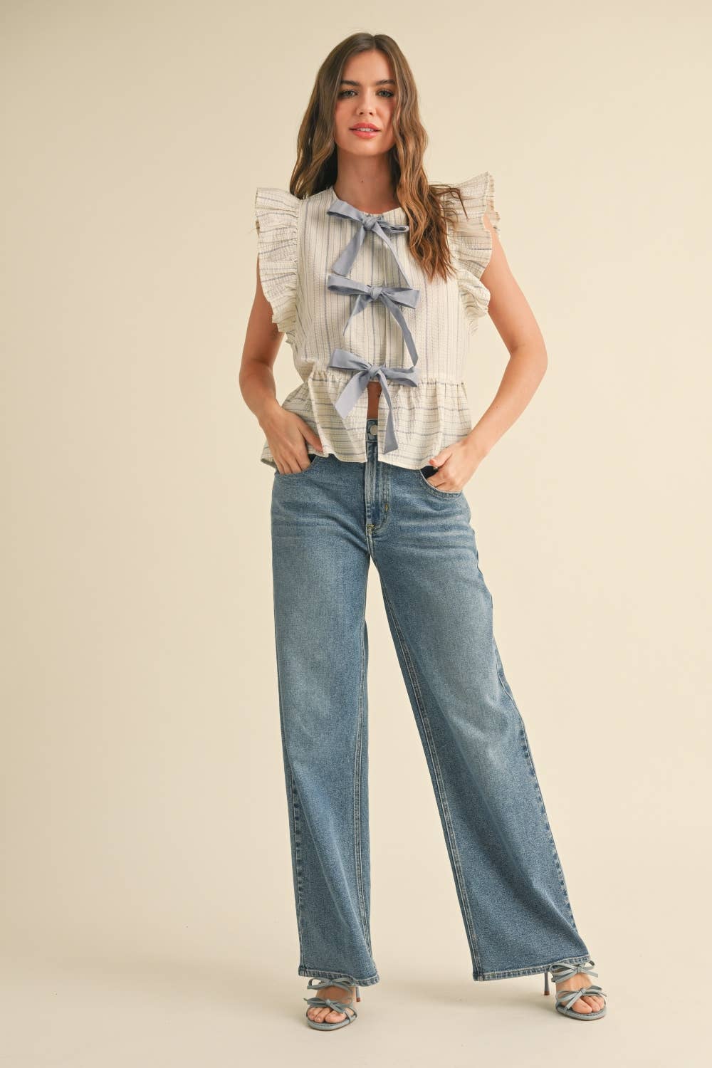 STRIPED WITH TIE FRONT RUFFLE SLEEVELESS BLOUSE: BLUE